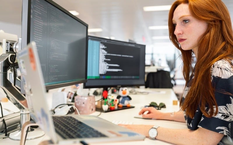 A woman in an office researching search as a service on her computer